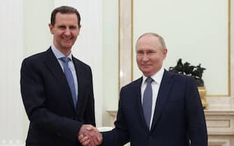 (FILES) In this file pool photograph distributed by the Russian state agency Sputnik, Russia's President Vladimir Putin (R) shakes hands with his Syrian counterpart Bashar al-Assad during their meeting at the Kremlin in Moscow on July 24, 2024. Islamist-led rebels declared that they have taken Damascus in a lightning offensive on December 8, 2024 sending President Bashar al-Assad fleeing and ending five decades of Baath rule in Syria. (Photo by Valery SHARIFULIN / POOL / AFP) / Editor's note : this image is distributed by Russian state owned agency Sputnik