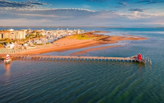 Lignano Panoramaic summer view from flying drone of Lignano Sabbiadoro town. Sunny outdoor scene of Adriatic coast of Italy with lighthous and old wooden pier