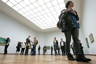 96343758 Visitors look at paintings by Dutch artist Vincent van Gogh, as part of the exhibition "Vincent van Gogh between Earth and Heaven: The landscapes" on April 23, 2009, at the Kunstmuseum in Basel. The exhibition, taking place from April 26, 2009 to September 27, is a retrospective of landscape paintings by the Dutch artist. AFP PHOTO/ NICHOLAS RATZENBOECK (Photo credit should read NICHOLAS RATZENBOECK/AFP via Getty Images)
